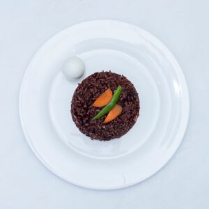 লাল চাল (আমন)
Lal chal (Aman ) Top-down view of Ghanaian Waakye with carrots and pepper on a white plate.